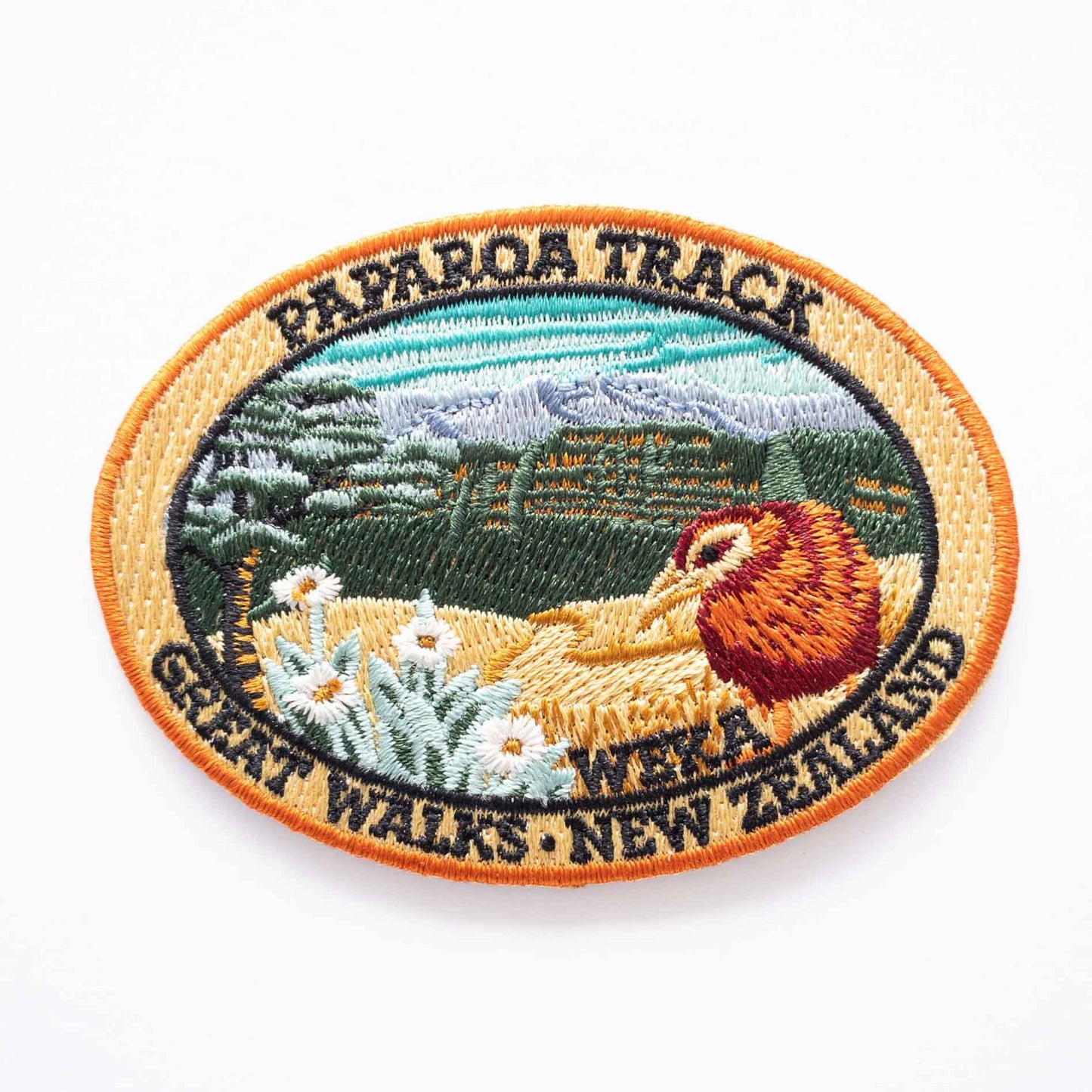 Oval, embroidered Paparoa Track patch, with a weka, green hills, mountain daisy and tussock.