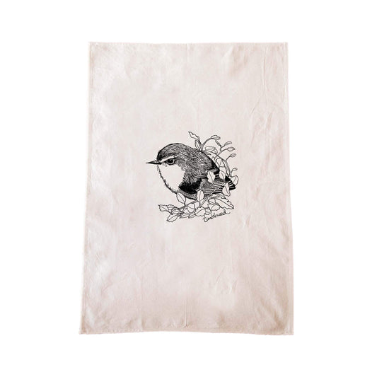 Off-white cotton tea towel with a screen printed titipounamu/rifleman design.